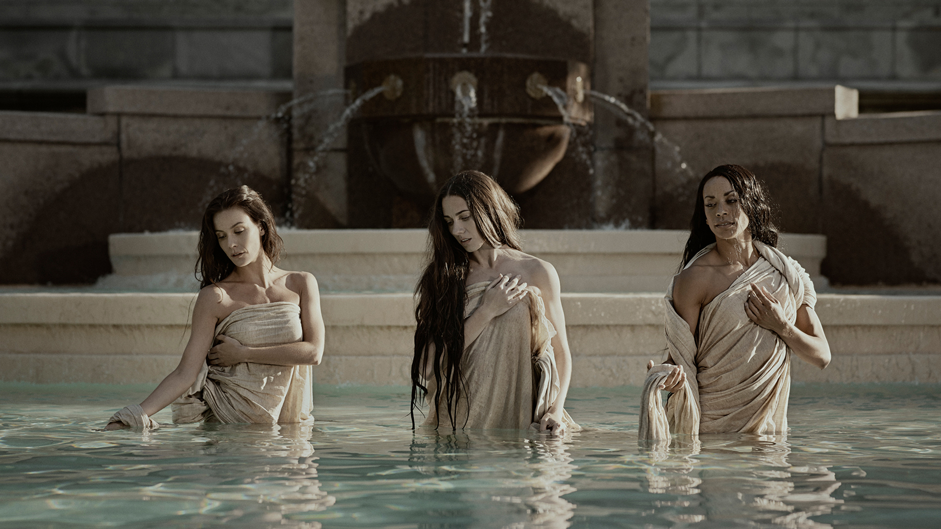 Three dancers in robes in a holy fountain represent the show Stabat MATER